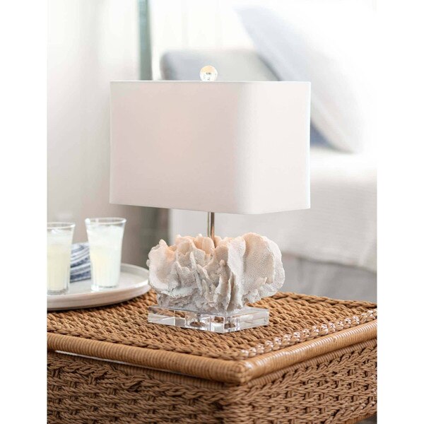 White coral table lamp on a wicker side table